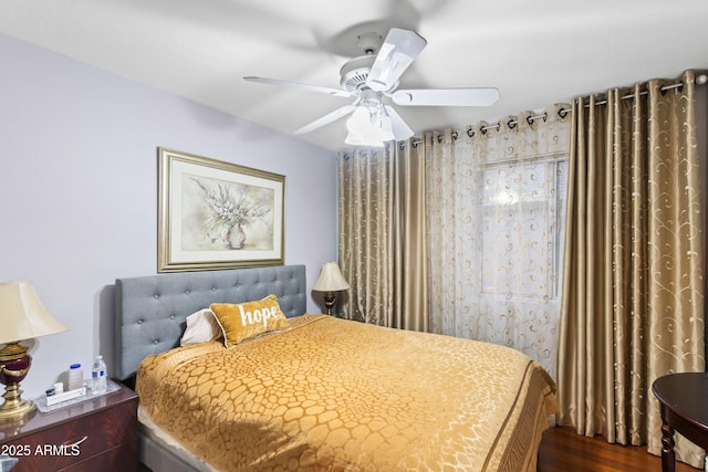 bedroom with dark wood-type flooring and ceiling fan