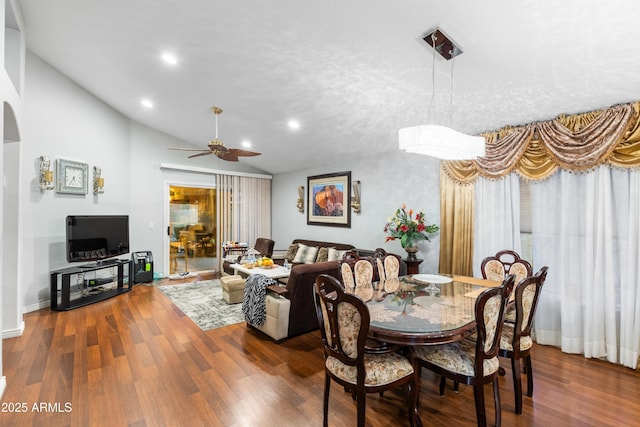 dining area featuring dark wood-type flooring, ceiling fan, and lofted ceiling