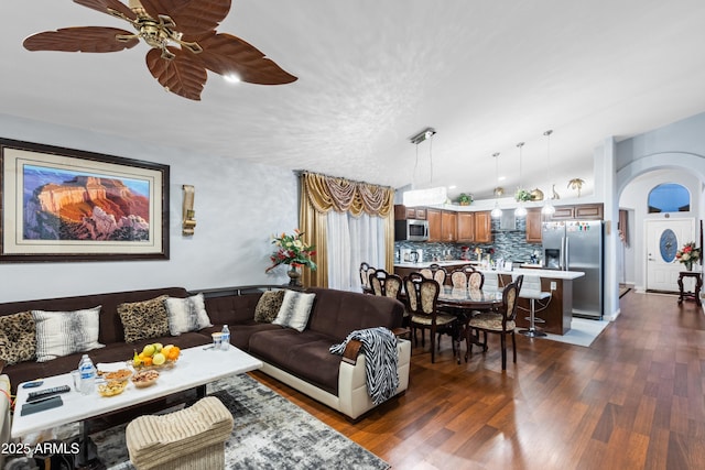 living room featuring ceiling fan and dark hardwood / wood-style floors