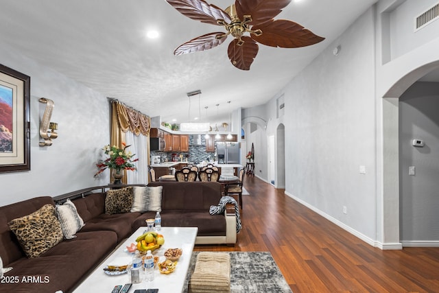 living room with ceiling fan and dark hardwood / wood-style floors