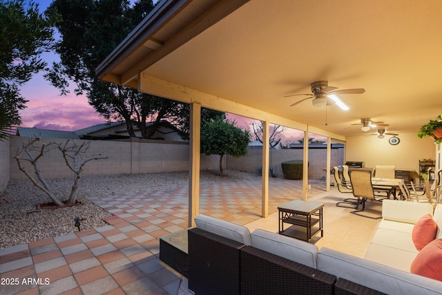 patio terrace at dusk with ceiling fan and outdoor lounge area