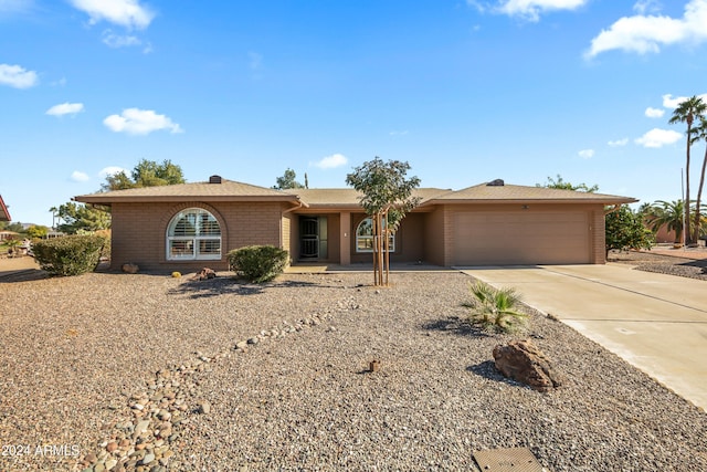 ranch-style home featuring a garage