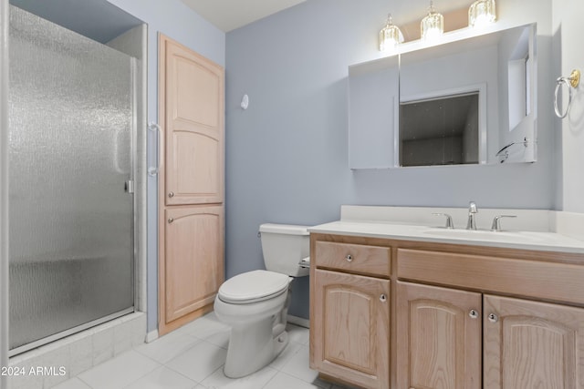 bathroom featuring tile patterned floors, vanity, toilet, and walk in shower