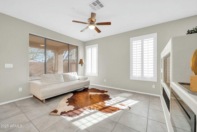 living room featuring light tile patterned flooring and ceiling fan