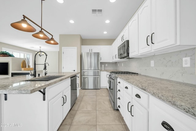 kitchen featuring sink, decorative light fixtures, stainless steel appliances, and white cabinets