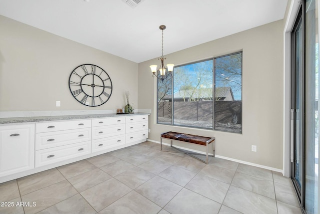 unfurnished dining area with light tile patterned floors and a chandelier