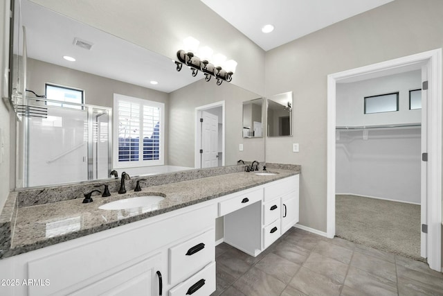 bathroom featuring vanity and a shower with shower door