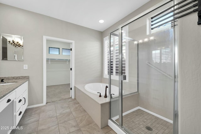 bathroom with vanity and separate shower and tub