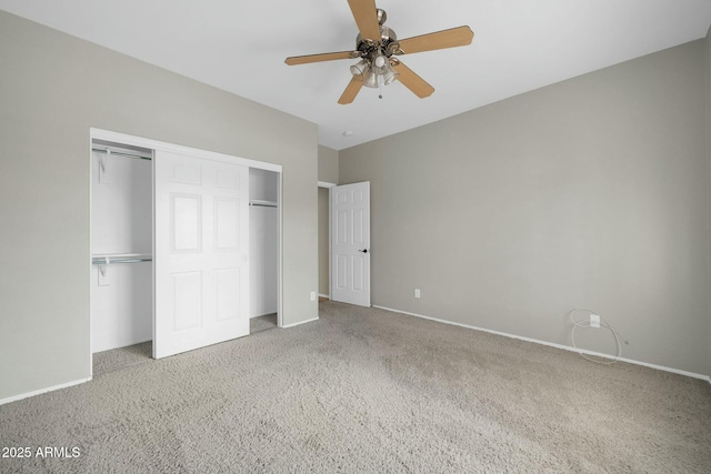 unfurnished bedroom with ceiling fan, a closet, and carpet