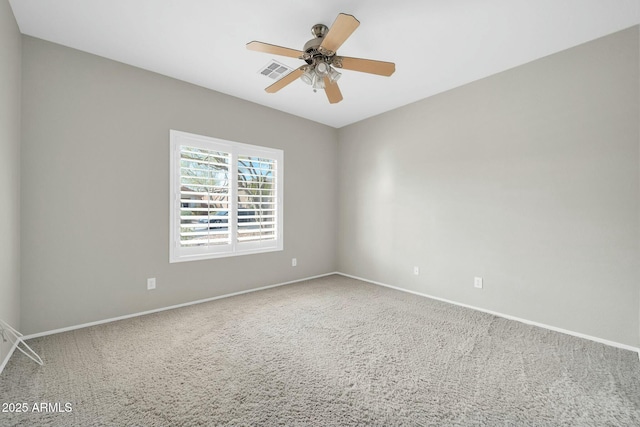 carpeted empty room featuring ceiling fan