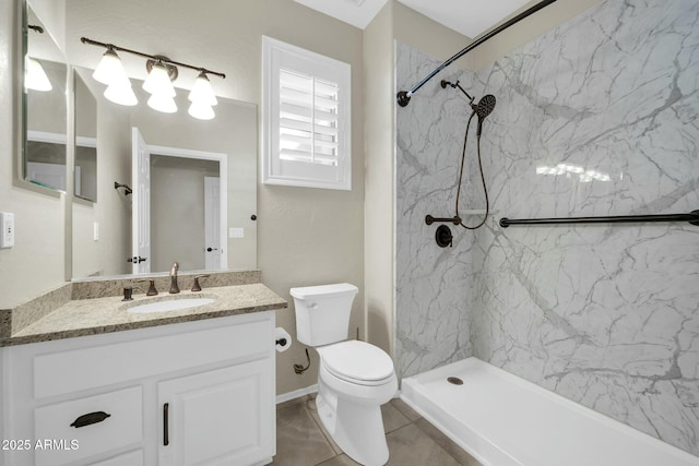 bathroom featuring tiled shower, vanity, and toilet