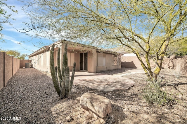 back of property with a patio area and central air condition unit