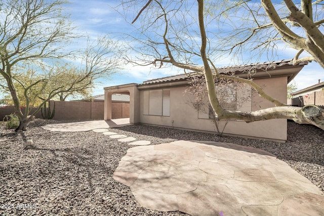 view of side of property with a patio area