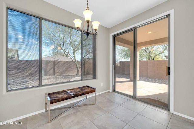 unfurnished dining area featuring tile patterned flooring and an inviting chandelier