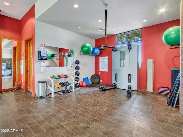 exercise room with hardwood / wood-style floors