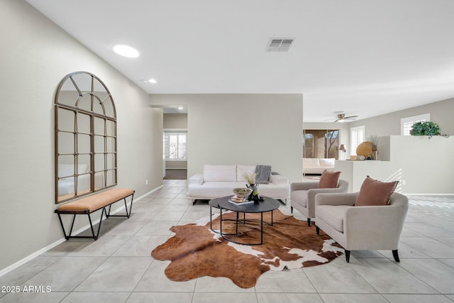 living room featuring light tile patterned flooring and ceiling fan