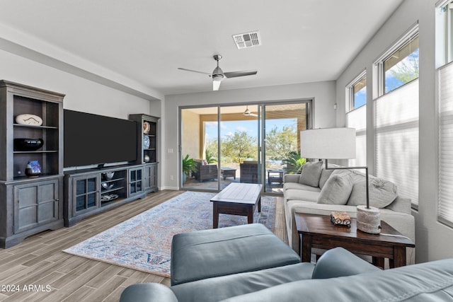 living room featuring light hardwood / wood-style flooring and ceiling fan