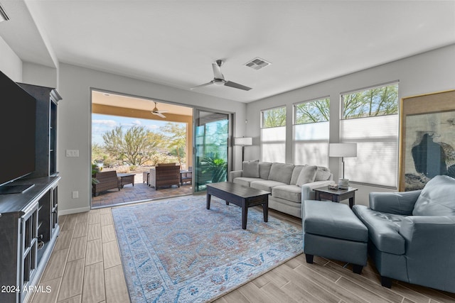 living room featuring ceiling fan and light hardwood / wood-style flooring