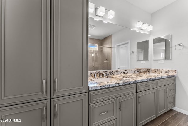 bathroom featuring vanity and tiled shower