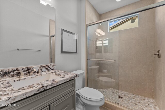 bathroom with vanity, toilet, and an enclosed shower