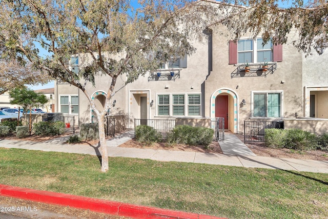 view of property featuring a front lawn