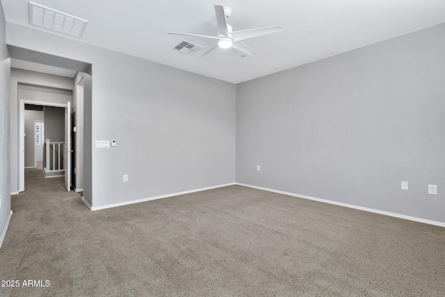 carpeted spare room with ceiling fan