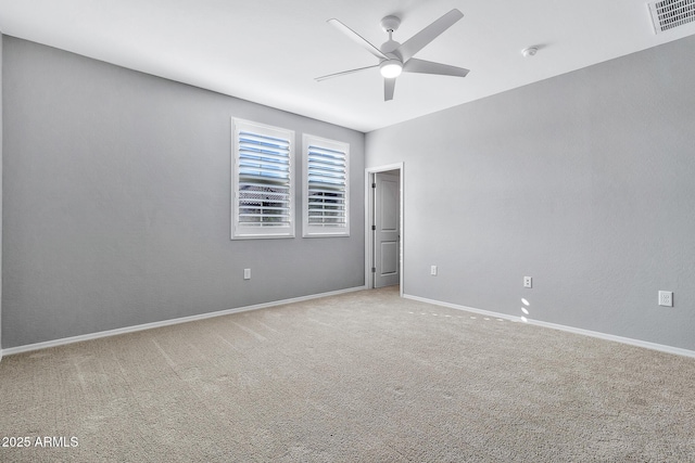 spare room with ceiling fan and carpet