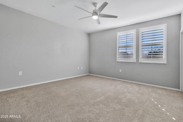 carpeted spare room with ceiling fan