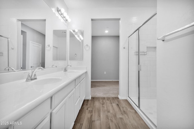 bathroom featuring vanity, hardwood / wood-style floors, and a shower with shower door