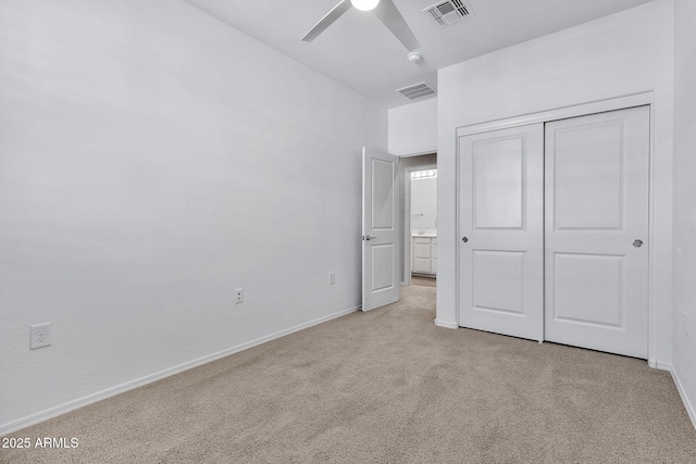 unfurnished bedroom featuring light carpet, ceiling fan, and a closet