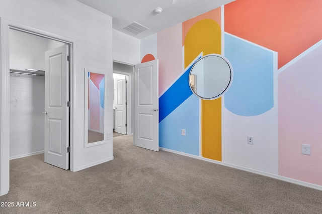 unfurnished bedroom featuring light colored carpet and a closet