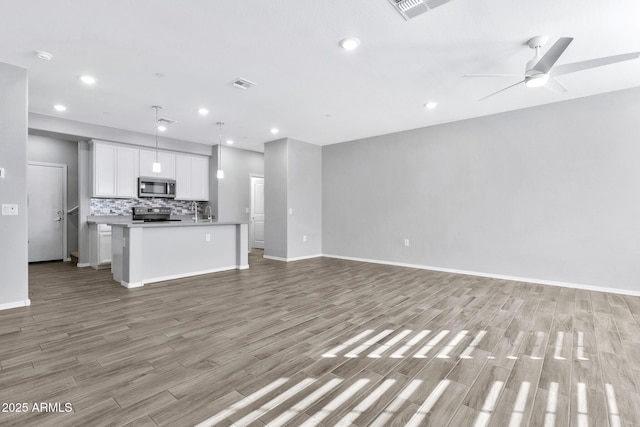 unfurnished living room featuring light hardwood / wood-style flooring and ceiling fan