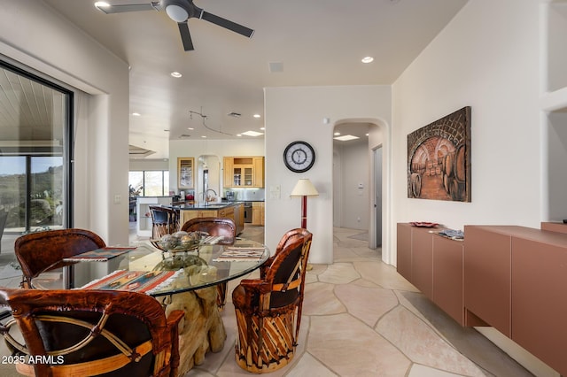 dining space with ceiling fan and sink