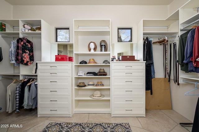 spacious closet with light tile patterned floors