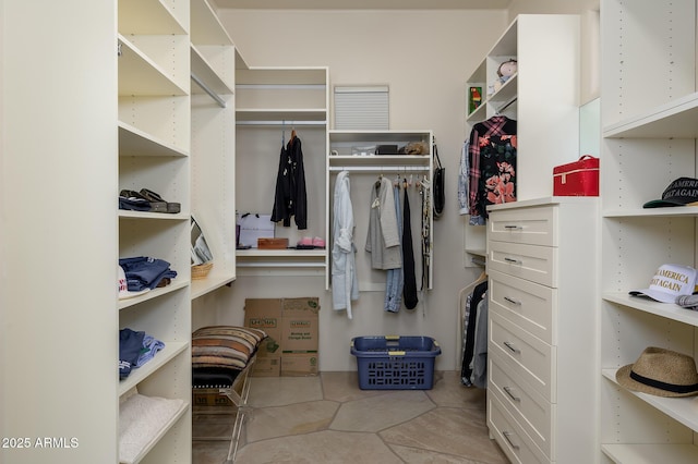 spacious closet featuring light tile patterned floors