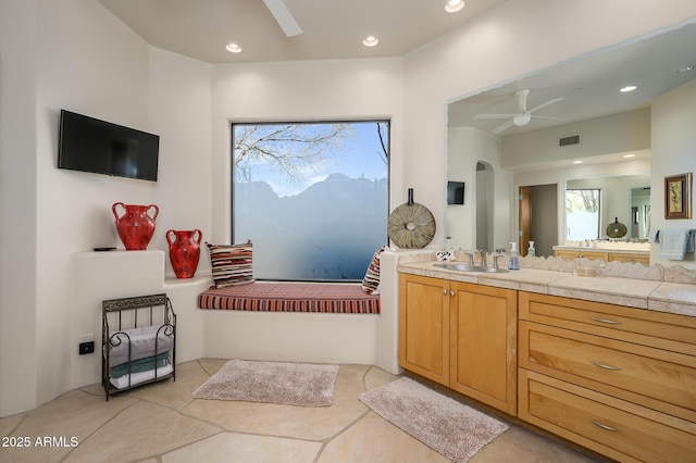 bathroom featuring ceiling fan, vanity, and tile patterned flooring