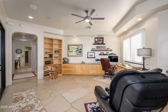 office area with light tile patterned floors, built in desk, built in features, and ceiling fan