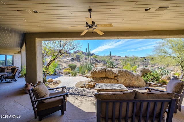 view of patio / terrace featuring ceiling fan, outdoor lounge area, and a mountain view