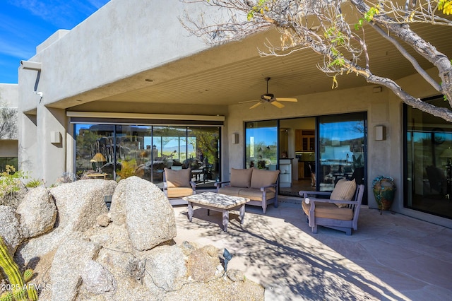 view of patio with an outdoor living space and ceiling fan