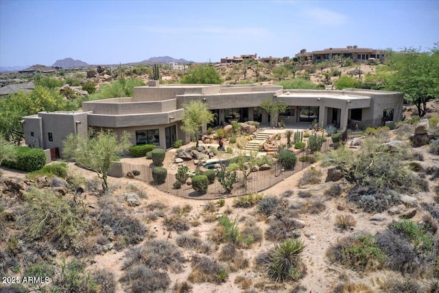 back of property with a mountain view