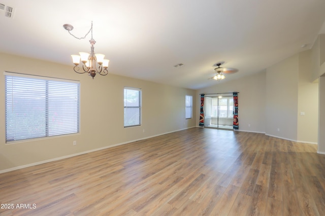 1563 E Peregrine Trl, Casa Grande, AZ 85122 - spare room featuring a chandelier, light wood finished floors, ceiling fan, baseboards, and vaulted ceiling