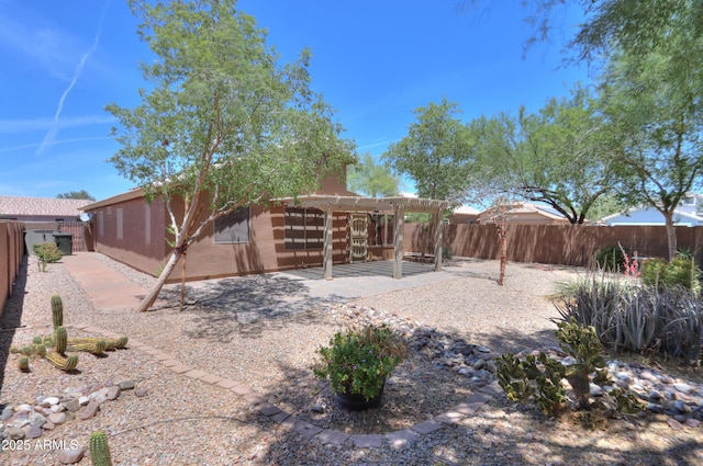 1563 E Peregrine Trl, Casa Grande, AZ 85122 - rear view of house with a pergola, a patio, a fenced backyard, and stucco siding
