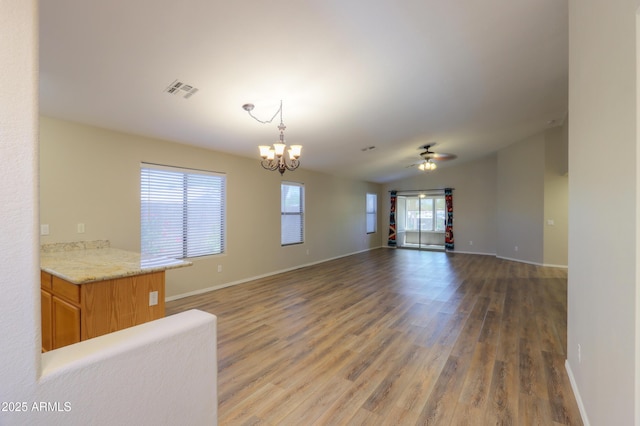 1563 E Peregrine Trl, Casa Grande, AZ 85122 - unfurnished living room featuring light wood finished floors, a chandelier, baseboards, and ceiling fan