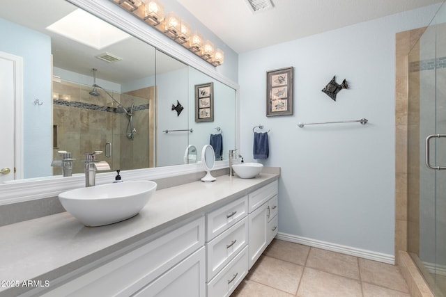 bathroom featuring walk in shower, vanity, and tile patterned flooring