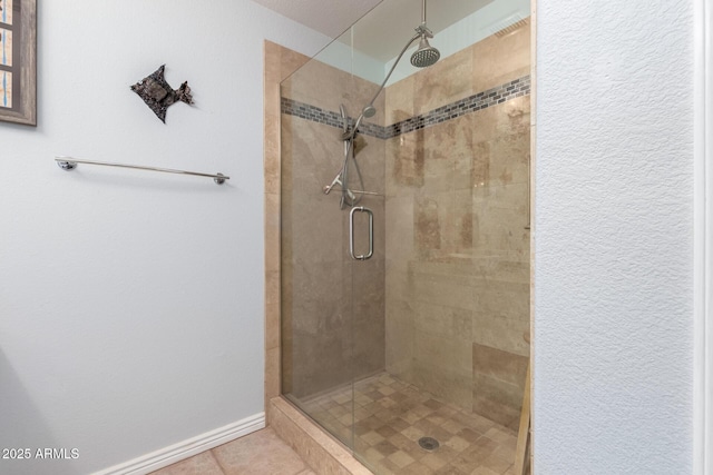 bathroom featuring an enclosed shower and tile patterned flooring