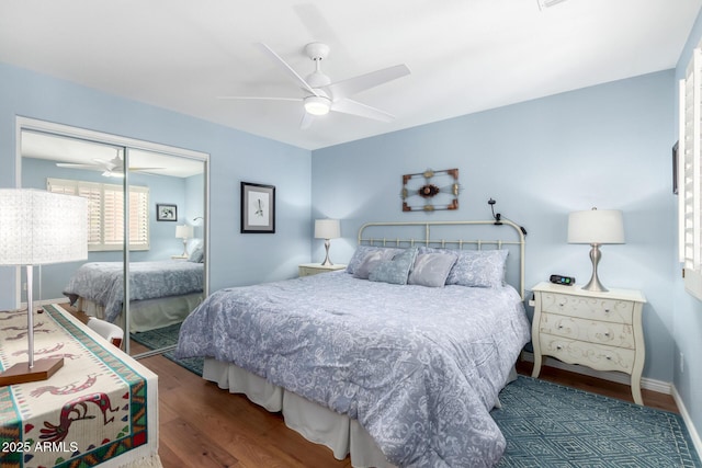 bedroom with dark hardwood / wood-style flooring, a closet, and ceiling fan