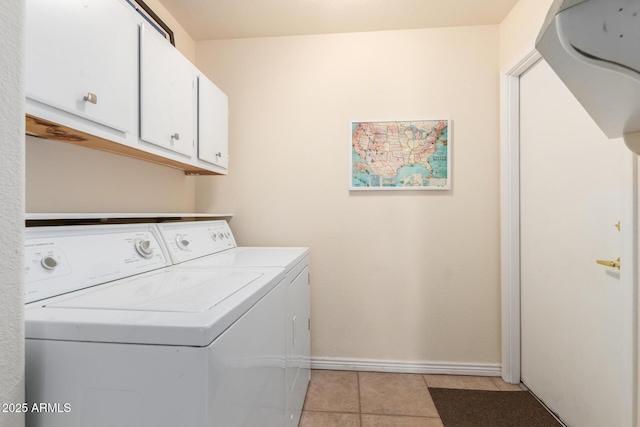 laundry area with cabinets, light tile patterned flooring, and separate washer and dryer