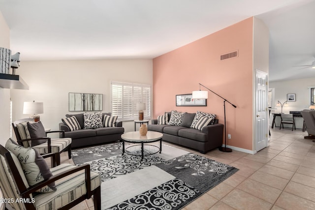 tiled living room with lofted ceiling and ceiling fan