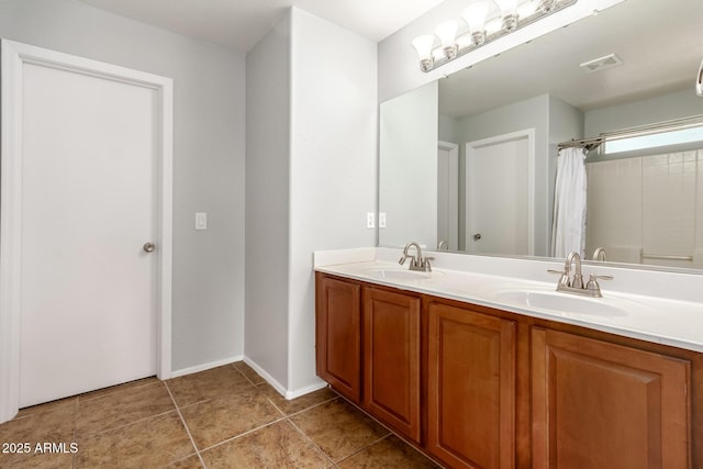 bathroom with visible vents, a sink, double vanity, and curtained shower