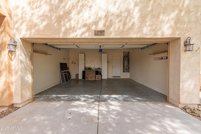 garage with driveway, a garage door opener, and secured water heater